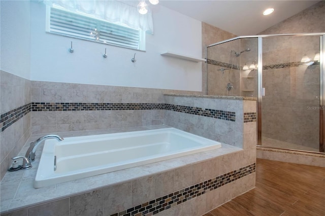 full bath featuring wood finished floors, a bath, and a shower stall