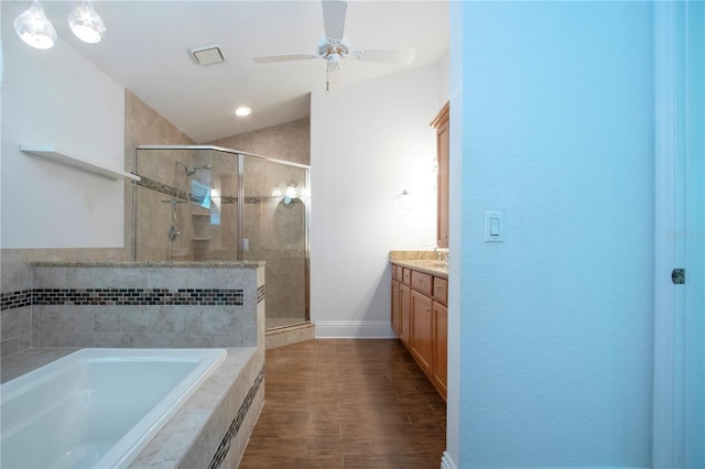 bathroom featuring a shower stall, ceiling fan, vaulted ceiling, a bath, and vanity