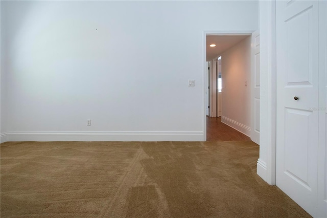 spare room featuring carpet flooring, recessed lighting, and baseboards