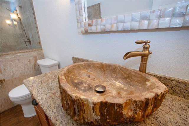 full bath with vanity, toilet, and a shower