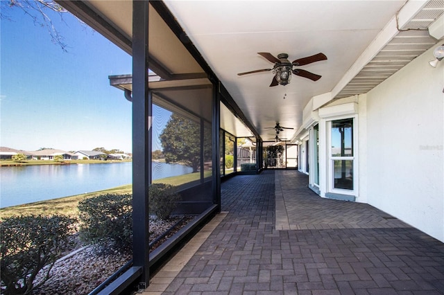 view of patio / terrace with visible vents, a ceiling fan, and a water view