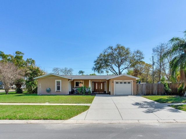 ranch-style home featuring fence, a front yard, stucco siding, driveway, and an attached garage