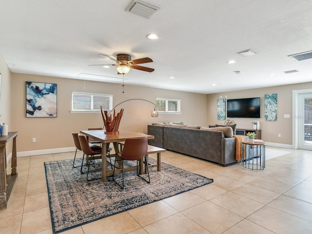 dining room with light tile patterned floors, visible vents, and baseboards