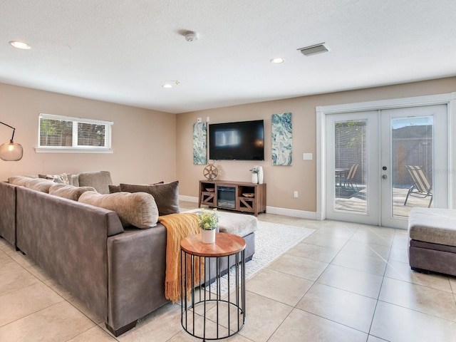 living room featuring visible vents, recessed lighting, french doors, light tile patterned floors, and baseboards