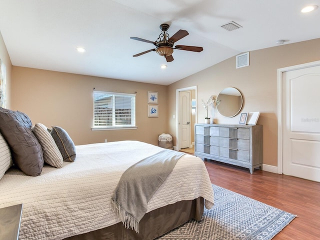 bedroom with vaulted ceiling, visible vents, recessed lighting, and wood finished floors