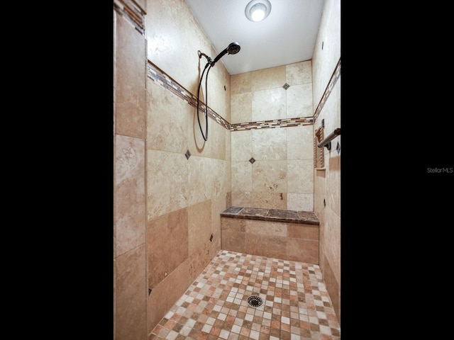 full bath featuring a tile shower