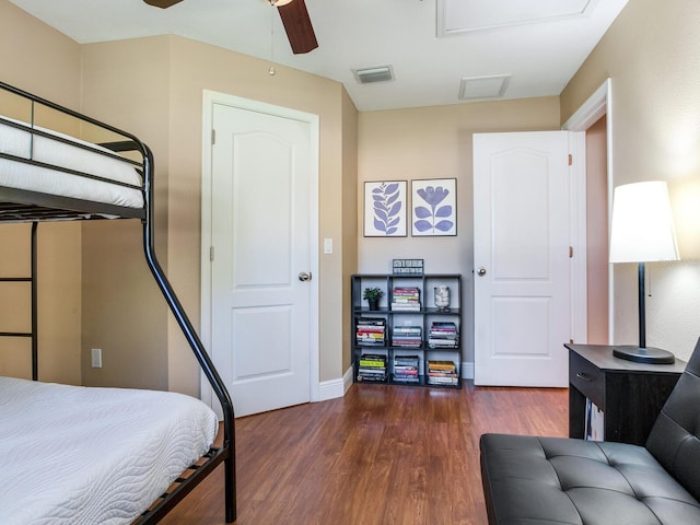 bedroom featuring dark wood finished floors, visible vents, a ceiling fan, and baseboards