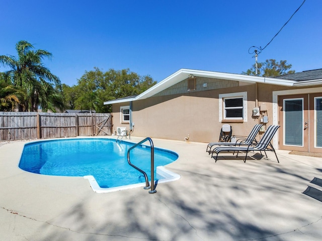 view of swimming pool with a fenced backyard, a fenced in pool, french doors, and a patio