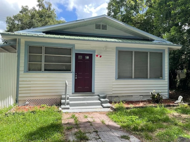 view of front of home featuring entry steps and metal roof