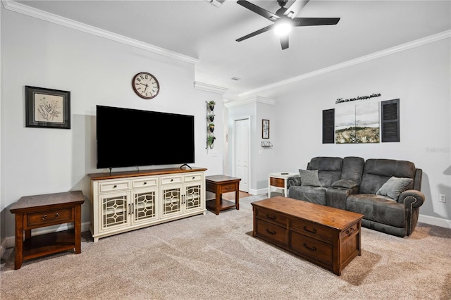 living room featuring light colored carpet, baseboards, ceiling fan, and ornamental molding