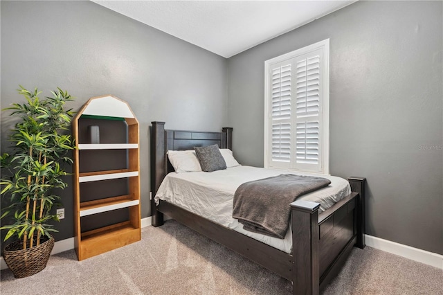 carpeted bedroom with baseboards