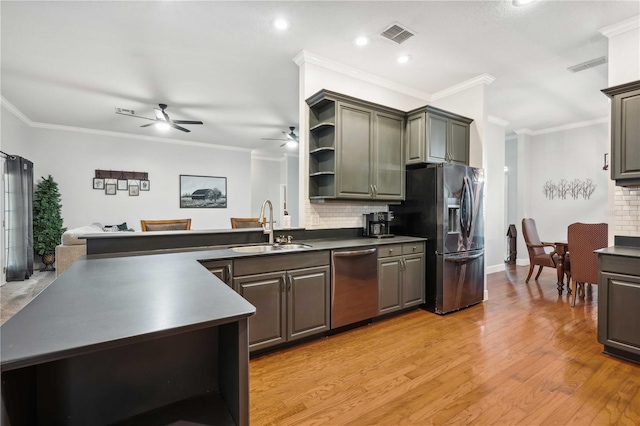 kitchen featuring light wood finished floors, backsplash, open shelves, appliances with stainless steel finishes, and a sink