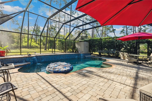 outdoor pool with glass enclosure and a patio