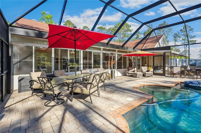 outdoor pool featuring glass enclosure, a patio, and an outdoor hangout area