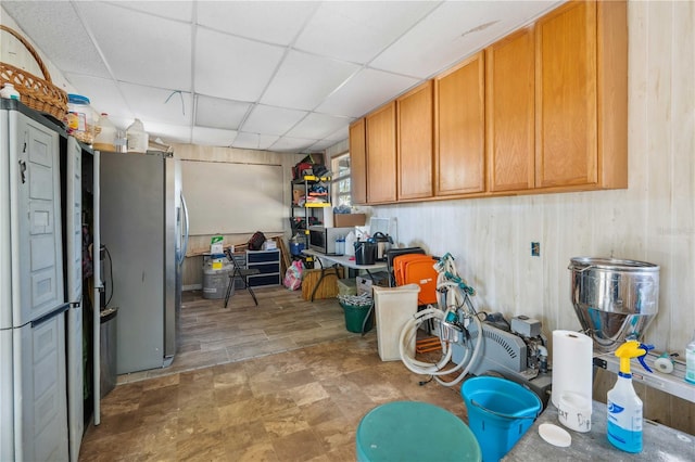 kitchen with a drop ceiling and stainless steel appliances