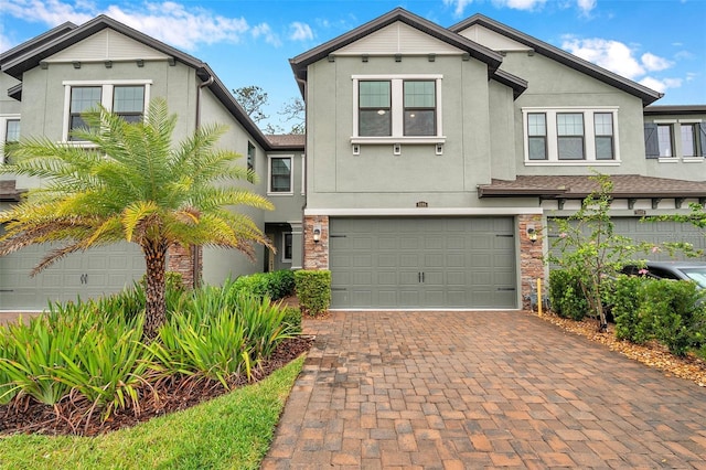 5086 San Martino Dr, Wesley Chapel, FL 33543 - view of front facade with stucco siding, decorative driveway, and a garage