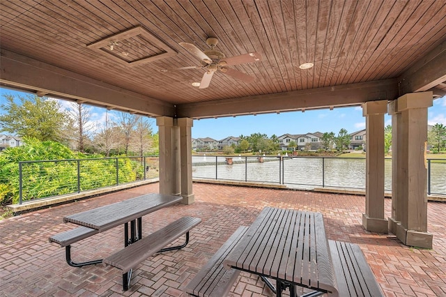 exterior space with a residential view, a water view, and ceiling fan