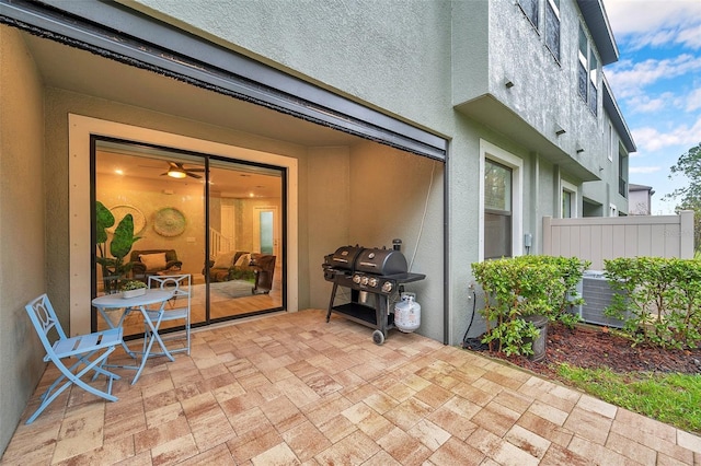 view of patio / terrace with area for grilling, central air condition unit, and fence