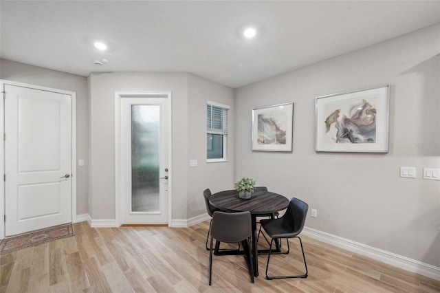 dining space with light wood finished floors, recessed lighting, and baseboards