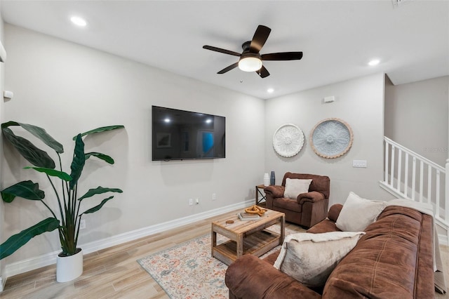 living area featuring ceiling fan, baseboards, stairway, recessed lighting, and wood finished floors