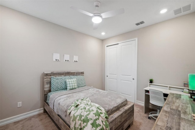 carpeted bedroom with visible vents, baseboards, a closet, and ceiling fan