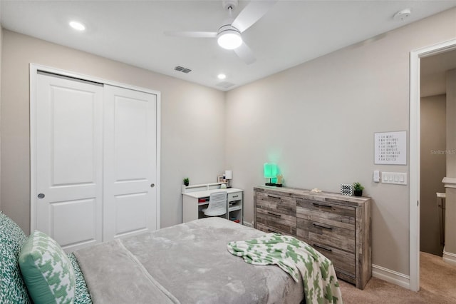 bedroom with visible vents, a ceiling fan, a closet, baseboards, and light colored carpet