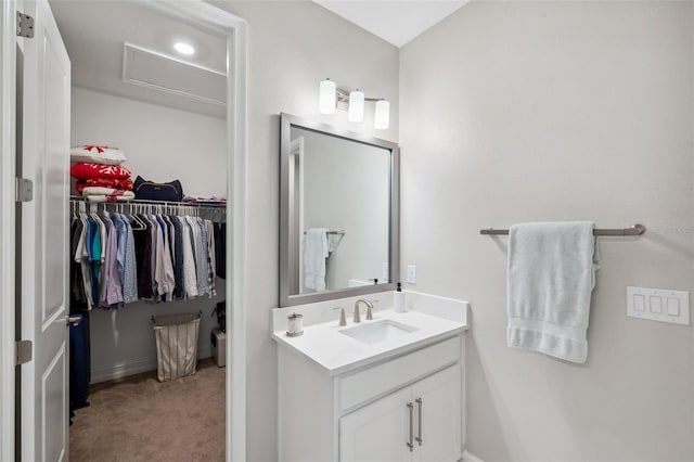 bathroom featuring vanity and a walk in closet