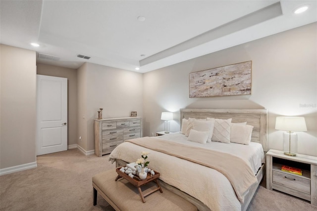 bedroom featuring recessed lighting, light colored carpet, a raised ceiling, and baseboards