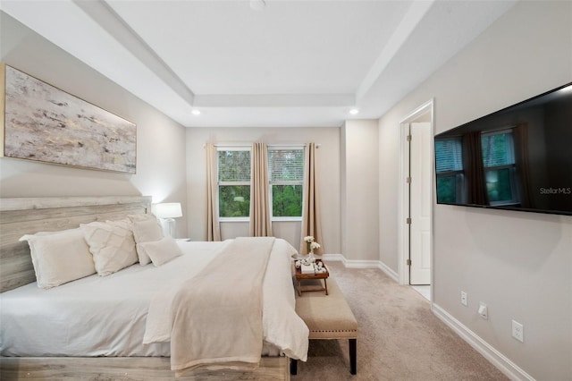 carpeted bedroom featuring a raised ceiling, recessed lighting, and baseboards