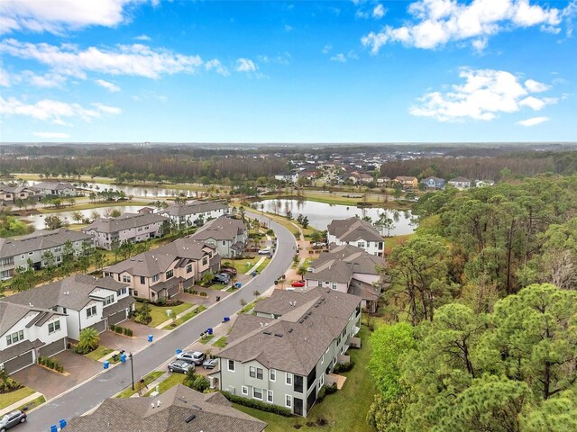 drone / aerial view featuring a residential view and a water view