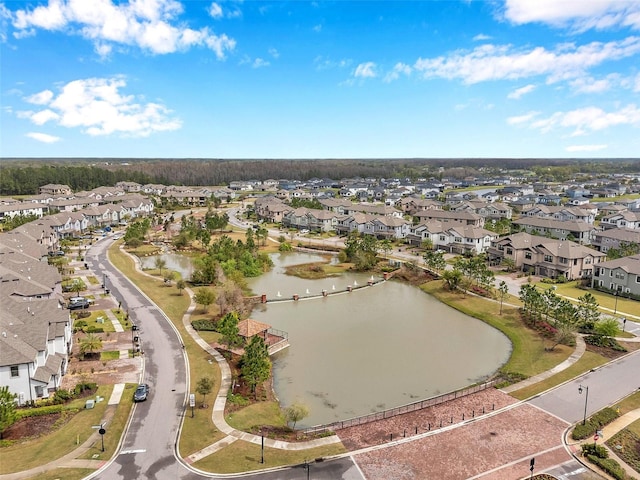 drone / aerial view with a residential view and a water view