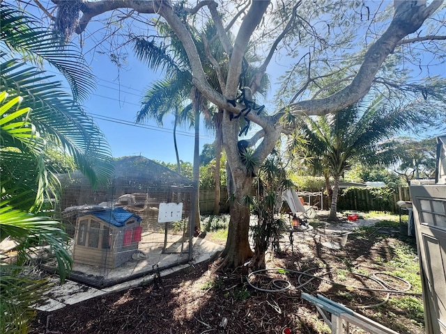 view of yard featuring an outbuilding, exterior structure, and a fenced backyard