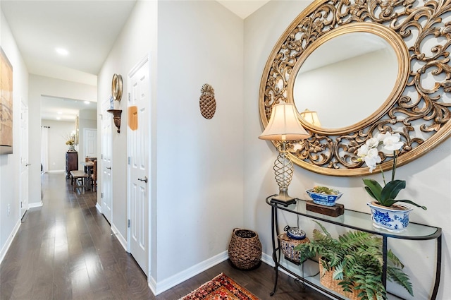 hall featuring hardwood / wood-style floors and baseboards