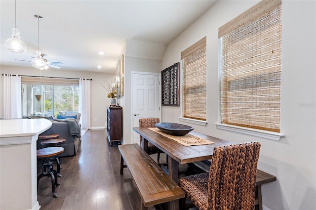 dining area featuring baseboards, dark wood finished floors, and a ceiling fan