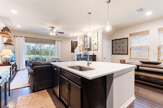 kitchen featuring visible vents, a sink, open floor plan, light countertops, and stainless steel dishwasher