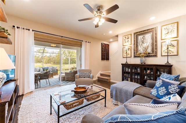 living room featuring stairway, recessed lighting, baseboards, and wood finished floors