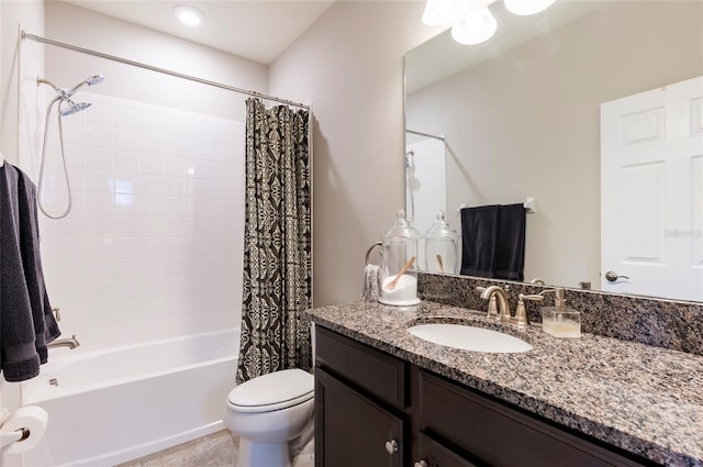 bathroom with toilet, vanity, and shower / bath combo