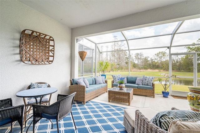 sunroom / solarium featuring a water view