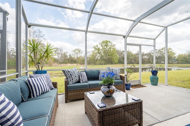 sunroom / solarium featuring a water view