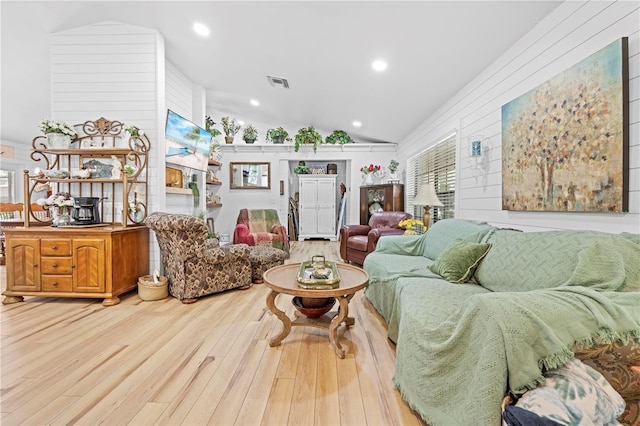 living room featuring recessed lighting, visible vents, lofted ceiling, and wood finished floors