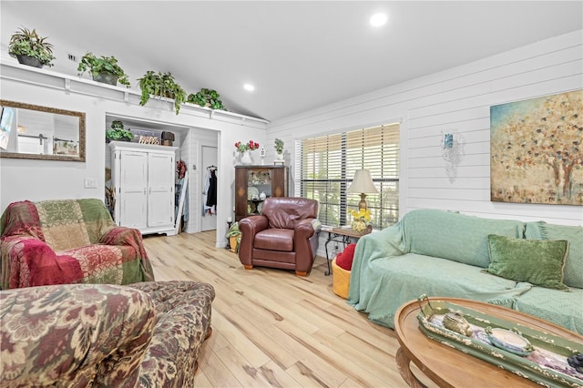 living room with vaulted ceiling, recessed lighting, and wood finished floors