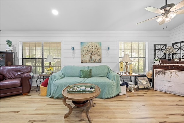 living room featuring ceiling fan, lofted ceiling, and wood finished floors