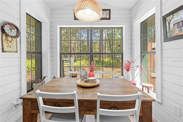 sunroom with a wealth of natural light and lofted ceiling