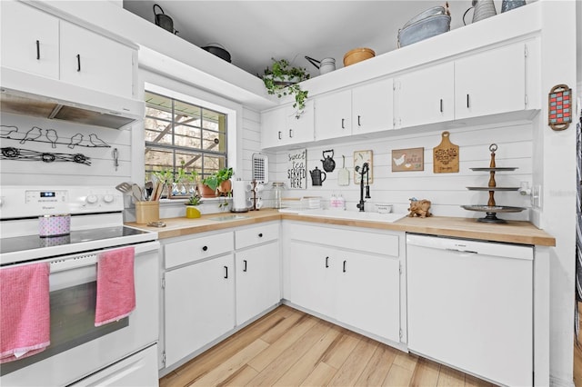 kitchen with white appliances, light wood finished floors, a sink, light countertops, and under cabinet range hood