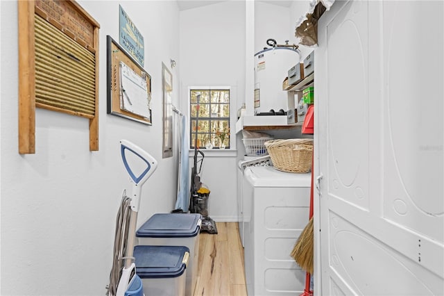 laundry room with laundry area, wood finished floors, and separate washer and dryer