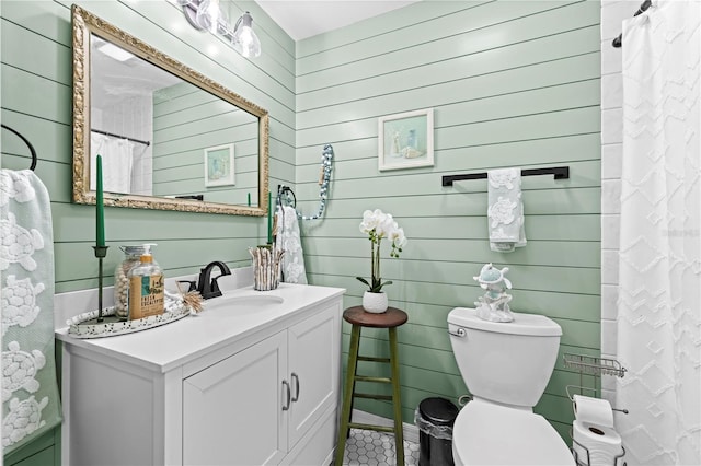 full bath featuring a shower with shower curtain, toilet, and vanity