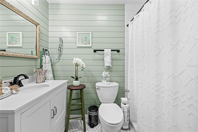 bathroom with vanity, curtained shower, toilet, and tile patterned flooring