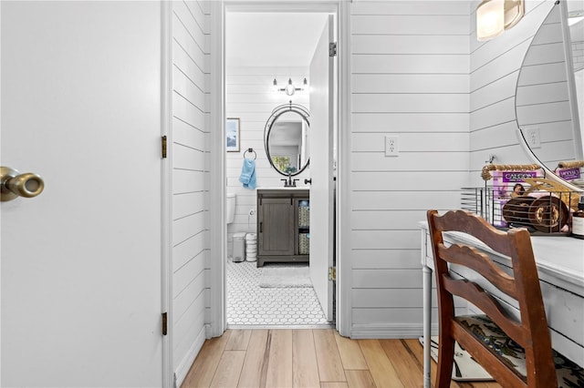 bathroom with wooden walls and wood finished floors