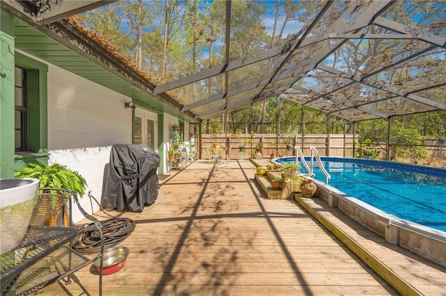 view of swimming pool featuring french doors, area for grilling, glass enclosure, and fence