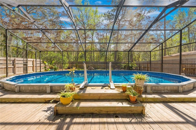 view of swimming pool featuring a fenced backyard, a fenced in pool, and a wooden deck